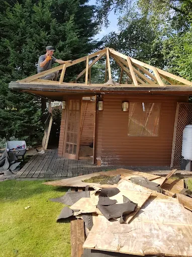 Garden outbuilding roof timbers being worked on during a clearance and rebuild project