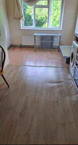 Empty, cleared room with laminate flooring after a house clearance