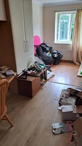 Bedroom with bagged items and boxes ready for house clearance