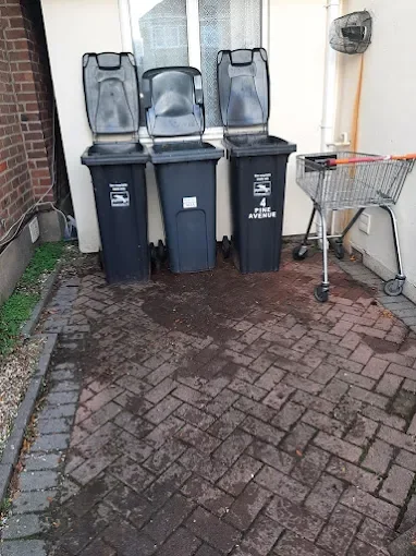 Wheelie bins and a shopping trolley cleared from outside a property